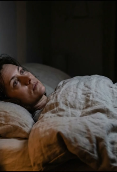 Woman awake in bed at night